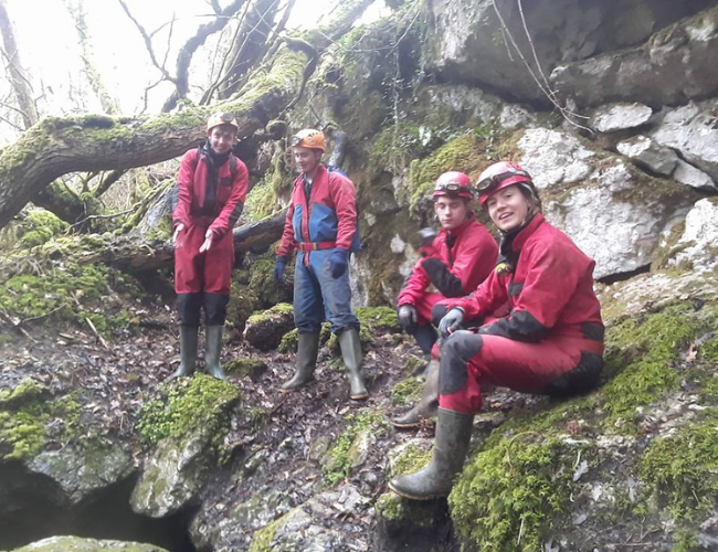 Caving & Potholing club members outside a cave